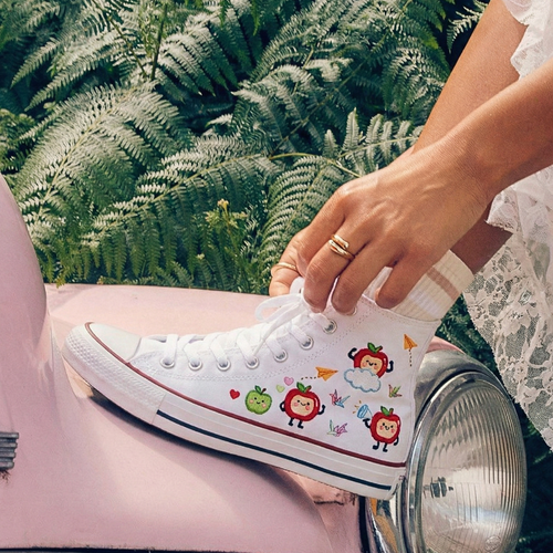 Person wearing a white sneaker with Love and Deepspace's Caleb designs.